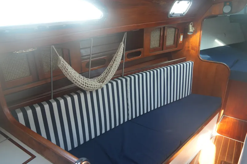 Slide: The Image of Interior of 1987 Ericson 32-200 sailboat with striped cushions and wooden finish. - 16
