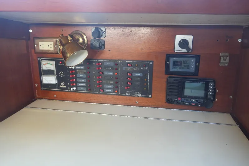 Slide: The Image of Electrical panel on 1987 Ericson 32-200 sailboat with switches, gauges, and radio equipment. - 18