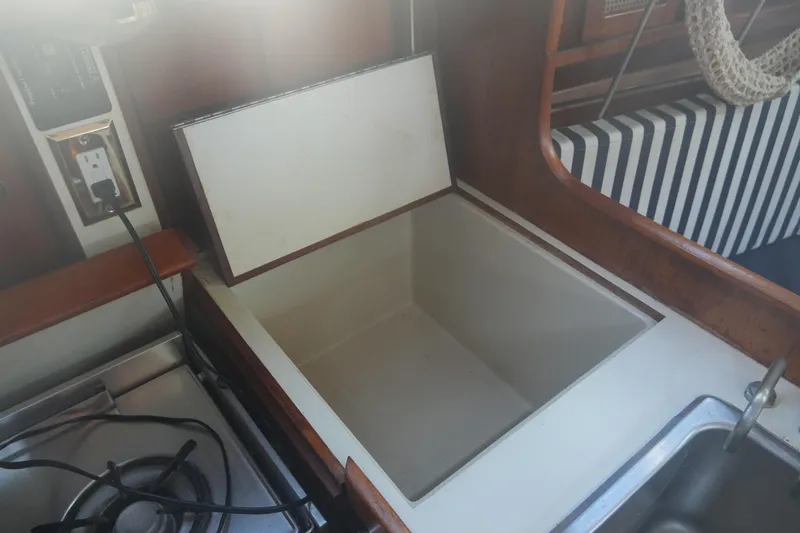 Slide: The Image of Open storage compartment in 1987 Ericson 32-200 yacht interior kitchen area. - 22