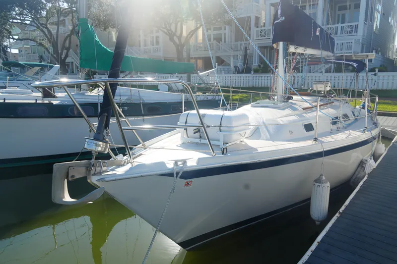 Slide: The Image of 1987 Ericson 32-200 sailboat docked in marina, sunlight reflecting on water. - 4
