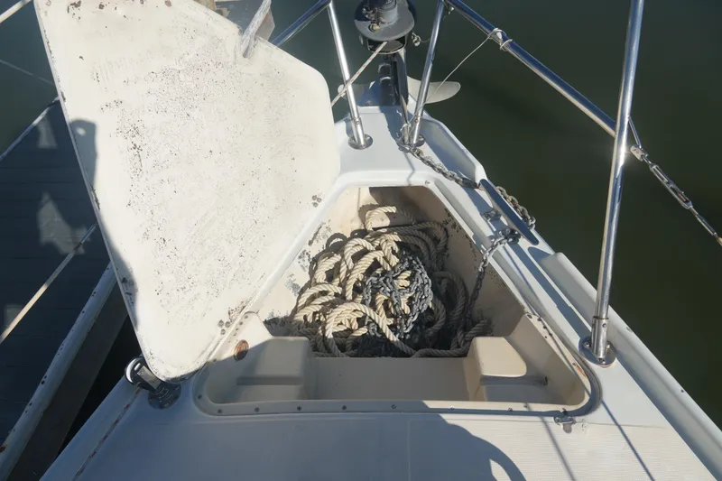 Slide: The Image of Open anchor locker on 1987 Ericson 32-200 sailboat, showing ropes and chains. - 5
