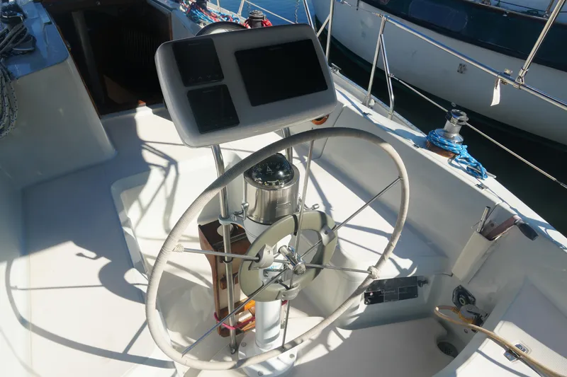 Slide: The Image of Steering wheel and controls of a 1987 Ericson 32-200 sailboat in sunlight. - 9