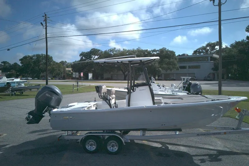 The Image of 2026 Sea Hunt BX 22 boat on trailer, parked outdoors under a clear sky. - 0