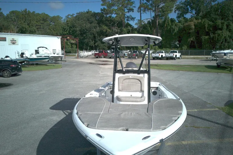 Slide: The Image of 2026 Sea Hunt BX 22 boat parked outdoors at a dealership with other vehicles. - 10