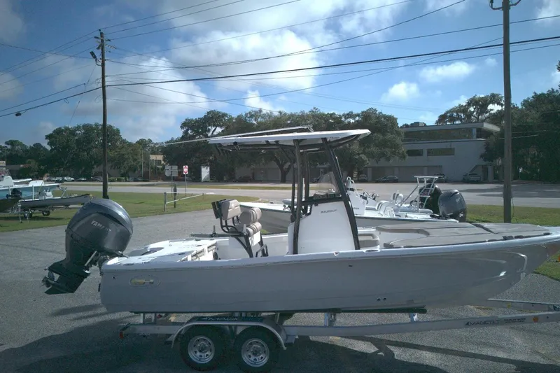 Slide: The Image of 2026 Sea Hunt BX 22 boat on trailer, parked outdoors under a clear sky. - 11