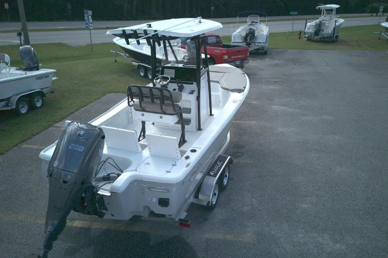 Slide: The Image of 2026 Sea Hunt BX 22 boat with Yamaha 200 engine on trailer in parking lot. - 2