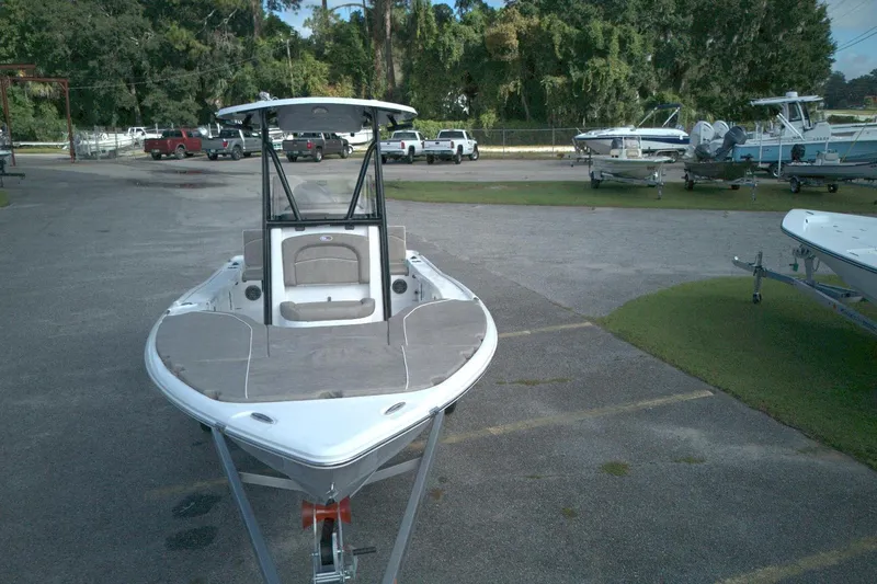 Slide: The Image of 2026 Sea Hunt BX 22 boat on trailer in outdoor lot, surrounded by trees and vehicles. - 3
