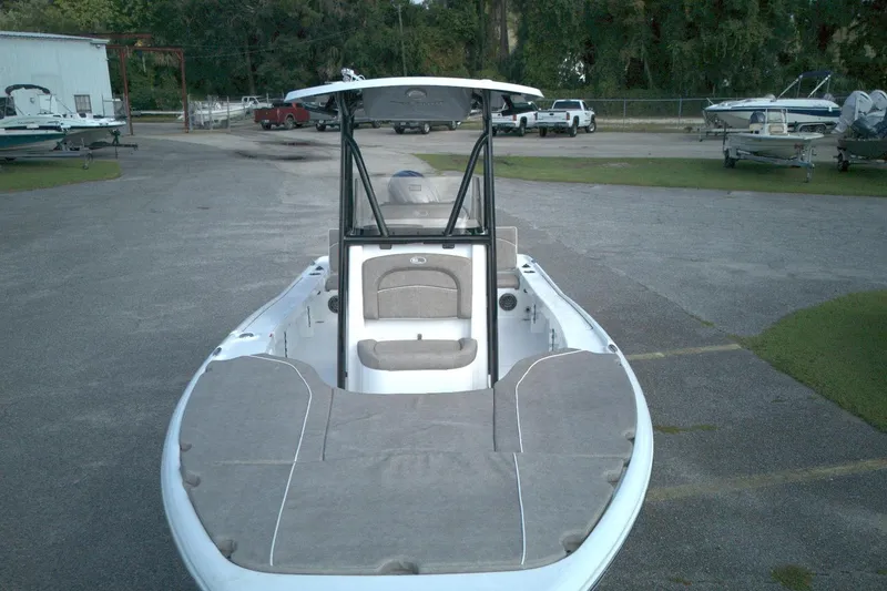 Slide: The Image of 2026 Sea Hunt BX 22 boat, parked outdoors, showcasing spacious deck and seating. - 6