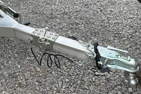 Slide: The Image of Trailer hitch of 2026 Thor LAKE HAMMER 1900 CC on gravel surface. - 3