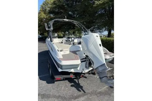 Slide: The Image of 2023 Tahoe 210 S boat, rear view, parked outdoors on a trailer. - 7
