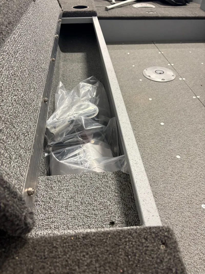 Slide: The Image of Lund 1400 Fury Tiller 2025 boat, interior view with storage compartment. - 10