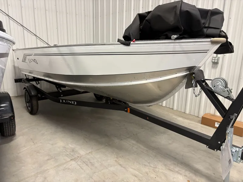 Slide: The Image of 2025 Lund 1400 Fury Tiller boat on trailer in warehouse. - 8
