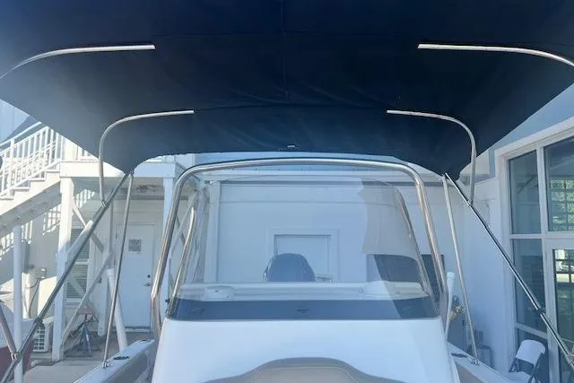 Slide: The Image of 2020 Key West 189 FS boat with canopy, docked near a building. - 10