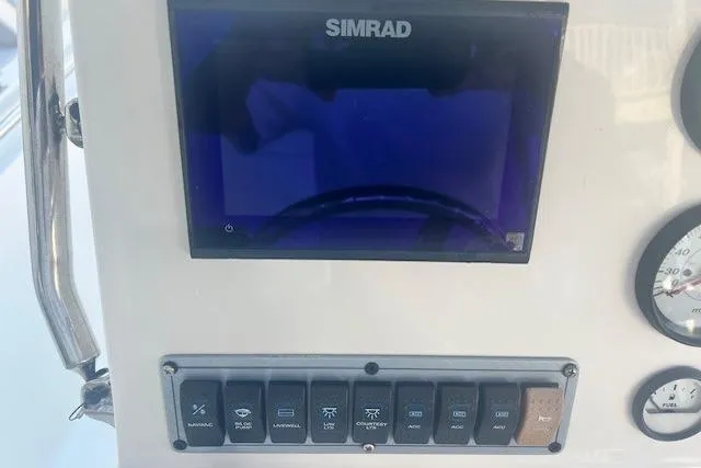 Slide: The Image of Control panel of 2020 Key West 189 FS boat with Simrad display and switches. - 4