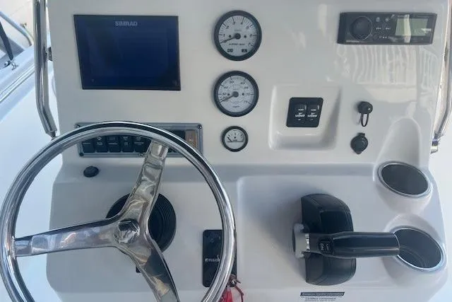 Slide: The Image of 2020 Key West 189 FS boat dashboard with steering wheel, gauges, and controls. - 6