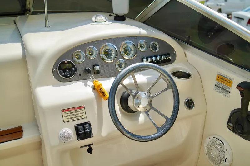 Slide: The Image of 2001 Sea Ray 215 Express Cruiser dashboard with steering wheel and instrument panel. - 11