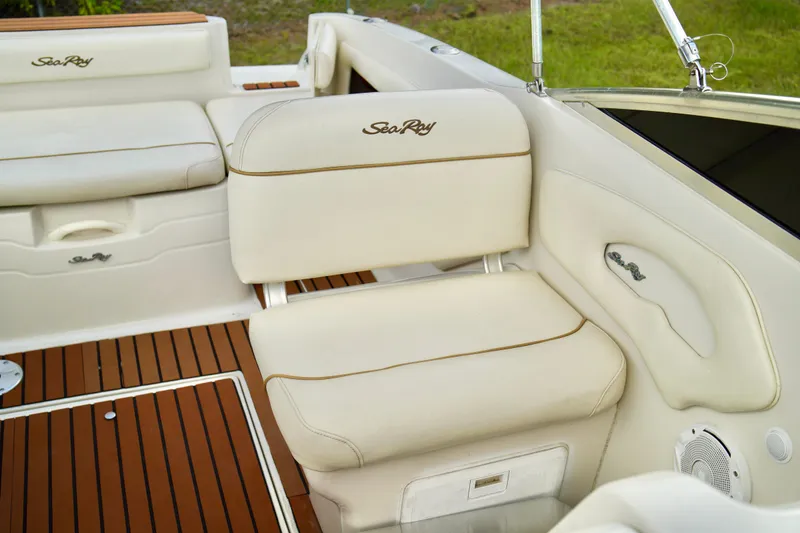 Slide: The Image of 2001 Sea Ray 215 Express Cruiser interior with cream seating and teak flooring. - 15