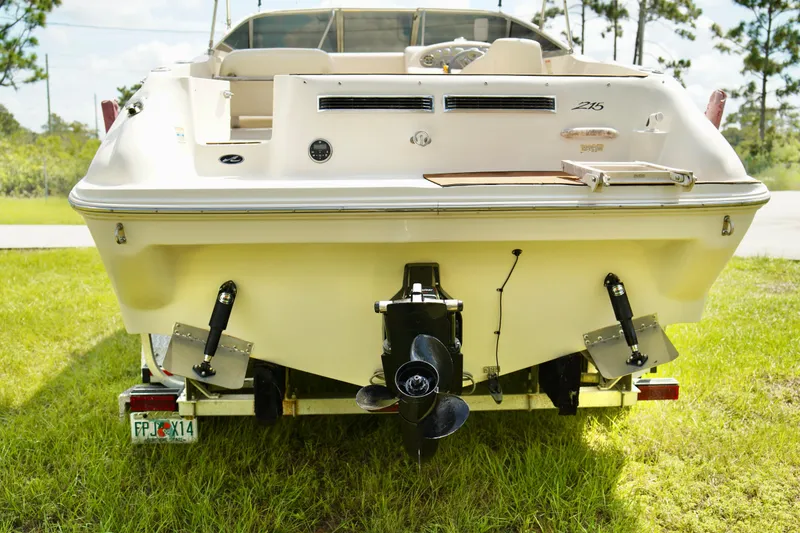 Slide: The Image of Rear view of 2001 Sea Ray 215 Express Cruiser on grass. - 20