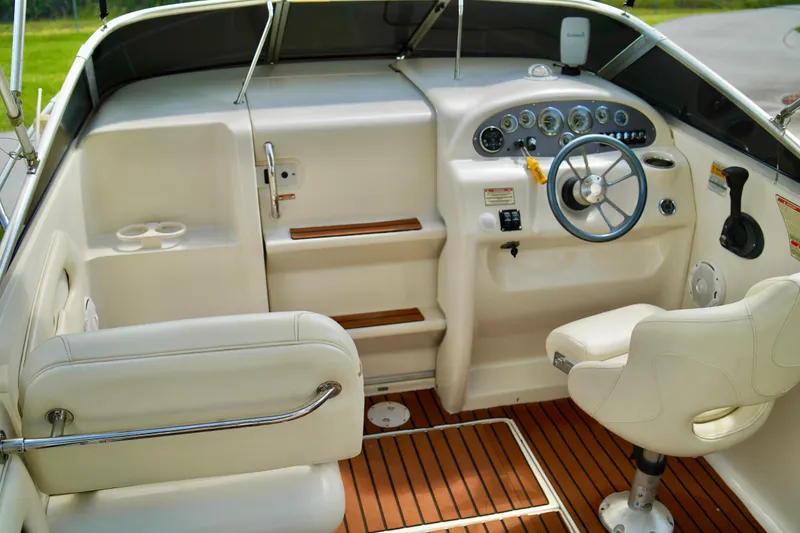 Slide: The Image of 2001 Sea Ray 215 Express Cruiser cockpit with steering wheel and control panel. - 8