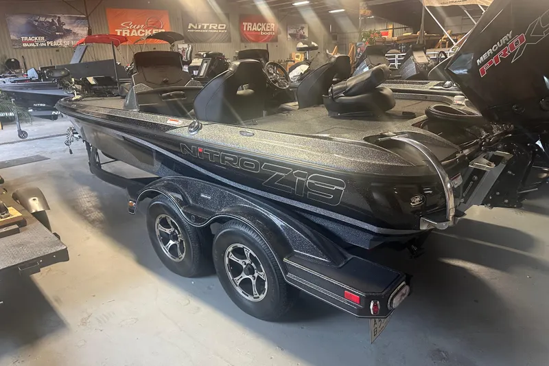 Slide: The Image of 2020 Nitro Z19 Pro boat in showroom, featuring sleek design and dual-axle trailer. - 10