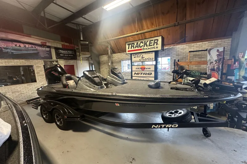 Slide: The Image of 2020 Nitro Z19 Pro bass boat in showroom with Tracker Boats signage. - 17