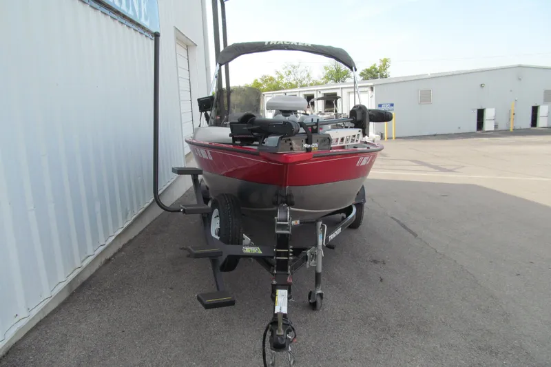Slide: The Image of 2012 Tracker Pro Guide V-16 SC boat on trailer, parked outdoors. - 11