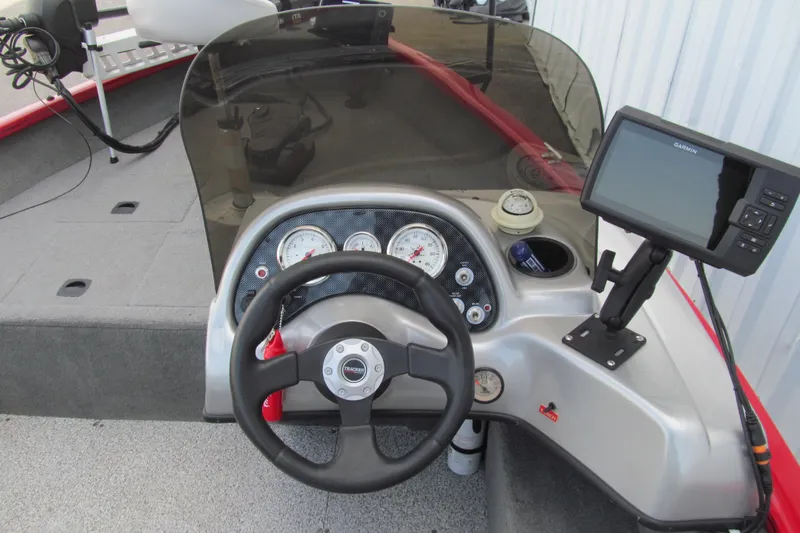 Slide: The Image of 2012 Tracker Pro Guide V-16 SC boat dashboard with steering wheel and Garmin display. - 6