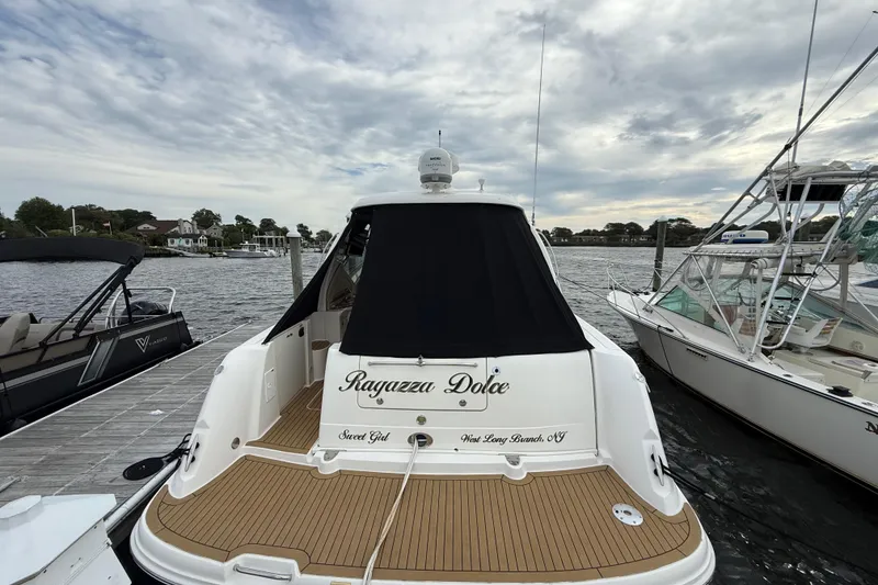 Slide: The Image of 2007 Sea Ray 40 Sundancer docked, rear view with "Ragazza Dolce" name. - 1