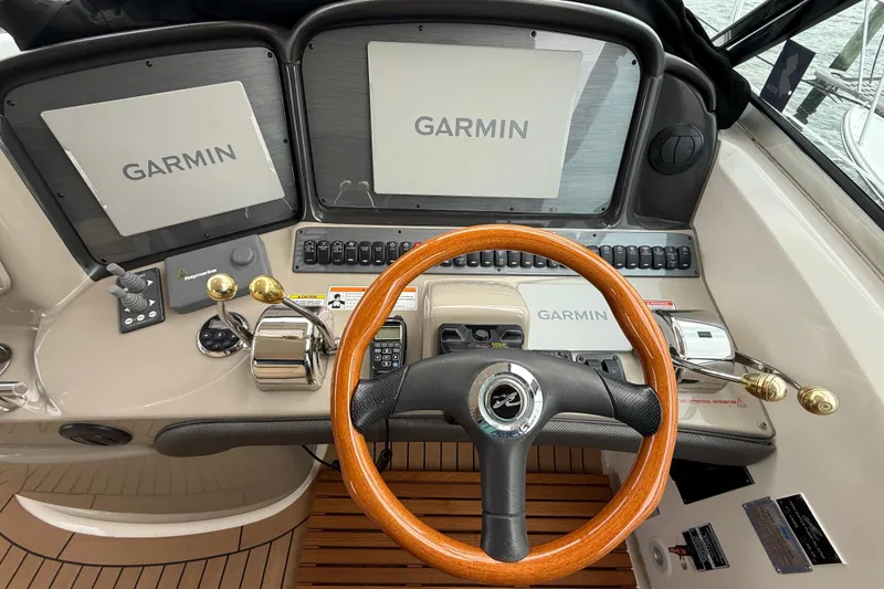 Slide: The Image of Helm of 2007 Sea Ray 40 Sundancer with Garmin navigation displays and wooden steering wheel. - 10