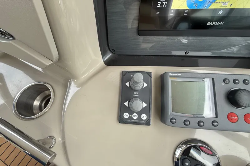 Slide: The Image of Control panel of a 2007 Sea Ray 40 Sundancer with Garmin and Raymarine displays. - 13