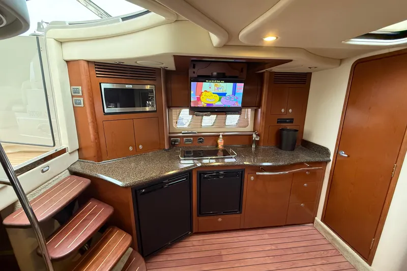 Slide: The Image of Interior of 2007 Sea Ray 40 Sundancer yacht with kitchenette and TV. - 18