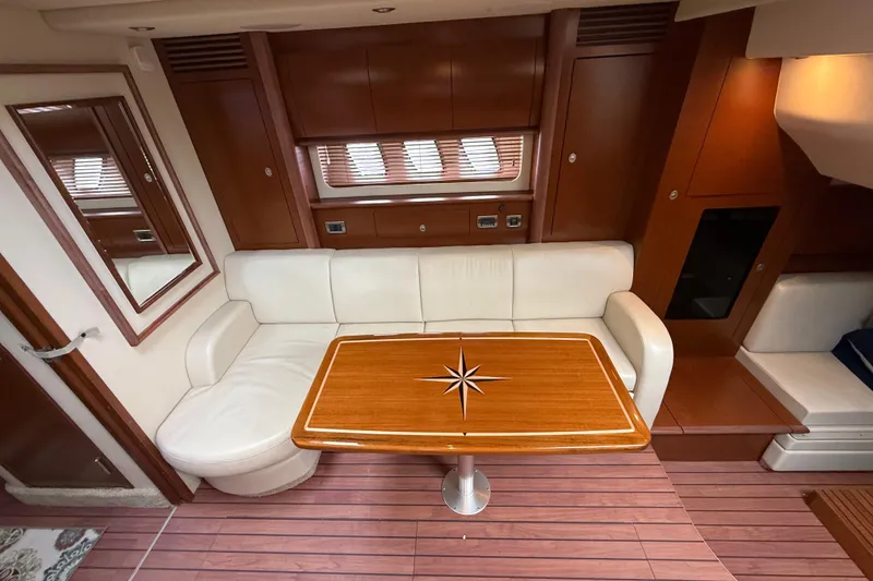 Slide: The Image of Luxurious 2007 Sea Ray 40 Sundancer interior with elegant seating and wooden table. - 19