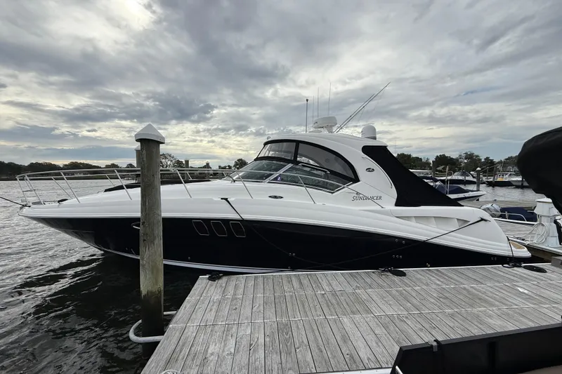 Slide: The Image of 2007 Sea Ray 40 Sundancer yacht docked under cloudy skies. - 2