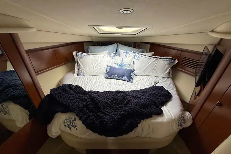 Slide: The Image of Luxurious cabin interior of 2007 Sea Ray 40 Sundancer with cozy bedding and elegant decor. - 21