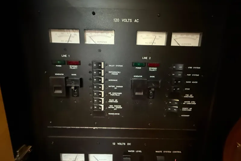 Slide: The Image of Electrical control panel on a 2007 Sea Ray 40 Sundancer boat, showing voltage and amperage meters. - 24