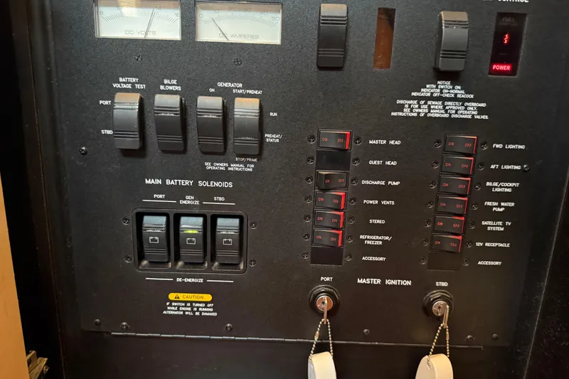 Slide: The Image of Control panel of a 2007 Sea Ray 40 Sundancer boat with switches and gauges. - 26