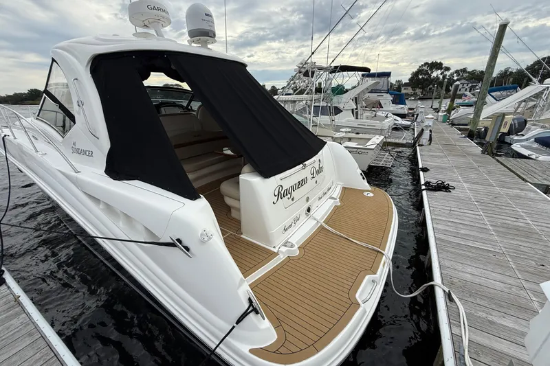 Slide: The Image of 2007 Sea Ray 40 Sundancer yacht docked at marina, featuring sleek design and spacious deck. - 3