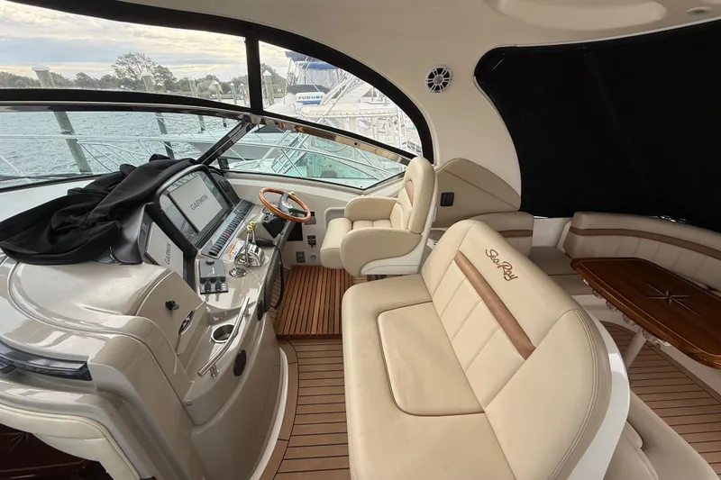 Slide: The Image of 2007 Sea Ray 40 Sundancer yacht interior with beige seating and modern navigation equipment. - 7