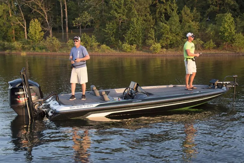 Slide: The Image of Manufacturer Provided Image: 2019 Skeeter ZX 250 fishing boat on a calm lake with two anglers. - 12