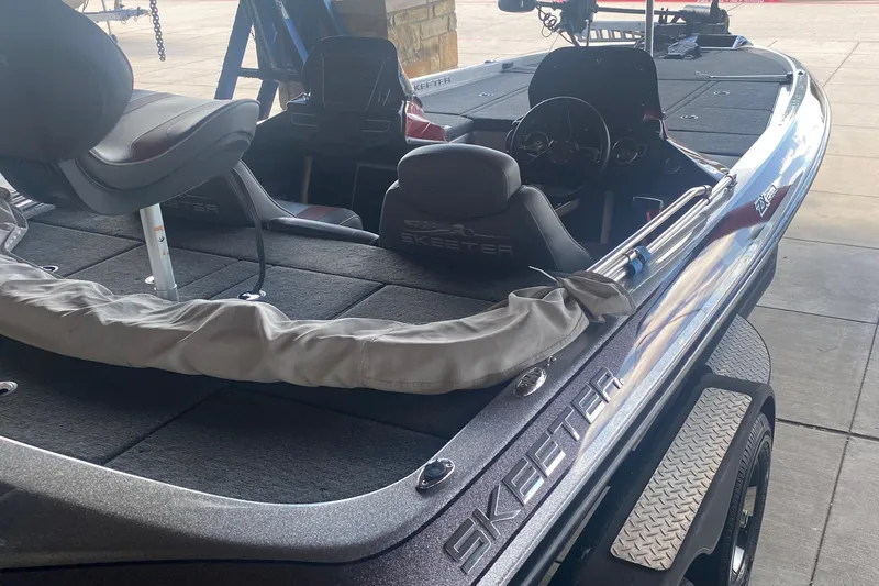 Slide: The Image of 2019 Skeeter ZX250 fishing boat interior with seating and steering wheel. - 2
