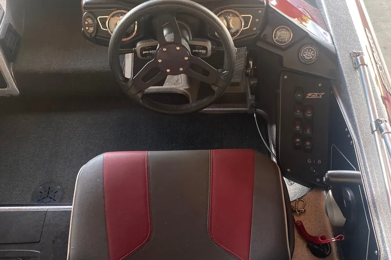 Slide: The Image of 2019 Skeeter ZX250 boat cockpit with steering wheel and control panel. - 6