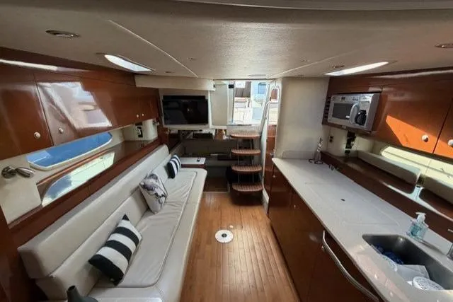 Slide: The Image of Interior of 2008 Sea Ray Sundancer 350 yacht with modern kitchen and cozy seating area. - 27