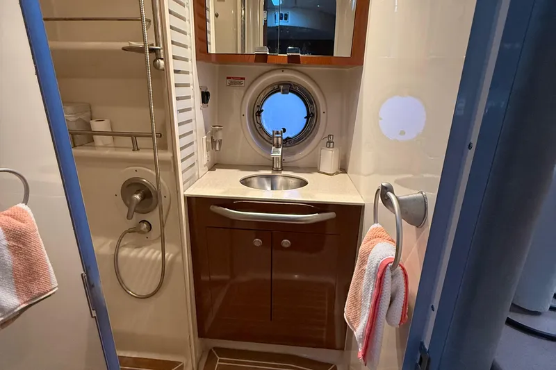 Slide: The Image of 2008 Sea Ray 350 Sundancer bathroom with sink, shower, and porthole window. - 13