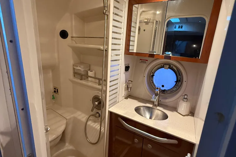 Slide: The Image of Bathroom interior of 2008 Sea Ray 350 Sundancer yacht with sink, mirror, and porthole. - 14