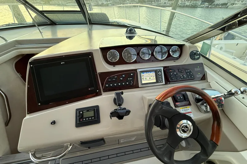 Slide: The Image of Helm of 2008 Sea Ray 350 Sundancer with gauges, controls, and steering wheel. - 16