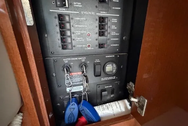 Slide: The Image of Electrical panel inside 2008 Sea Ray Sundancer 350 boat, featuring switches and ignition keys. - 35