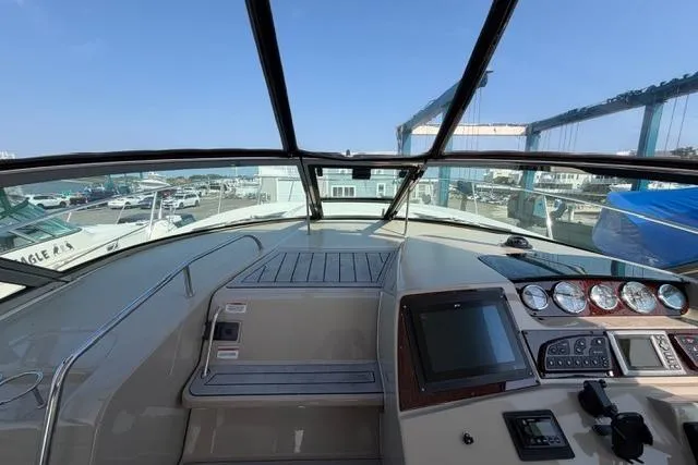 Slide: The Image of 2008 Sea Ray Sundancer 350 helm with navigation controls and marina view. - 19