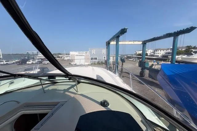 Slide: The Image of 2008 Sea Ray Sundancer 350 yacht on dry dock, marina view through windshield. - 39