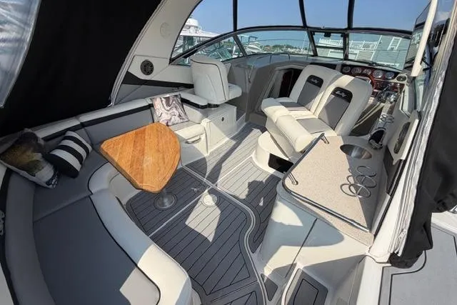 Slide: The Image of 2008 Sea Ray Sundancer 350 interior with seating, table, and helm in a sleek design. - 8