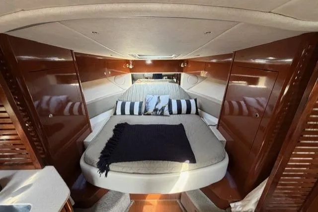 Slide: The Image of Interior cabin of 2008 Sea Ray Sundancer 350 with cozy bed and elegant wood finish. - 26